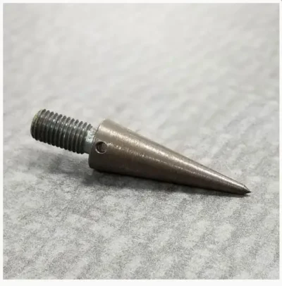 Metal cone with threaded end on surface.