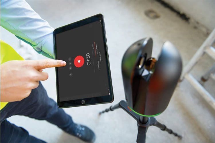 Person using tablet near recording device.