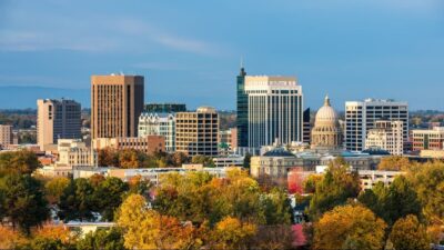 City skyline with autumn trees and buildings.