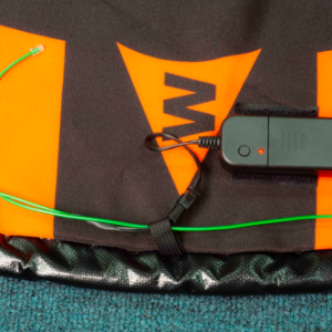 A black and orange Hoodman Green LED Light Kit for 3-5 Foot Drone Landing Pads with a green cord attached to it.