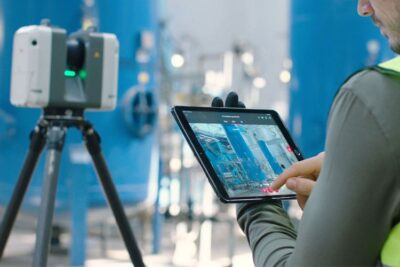 Person using tablet in industrial setting.
