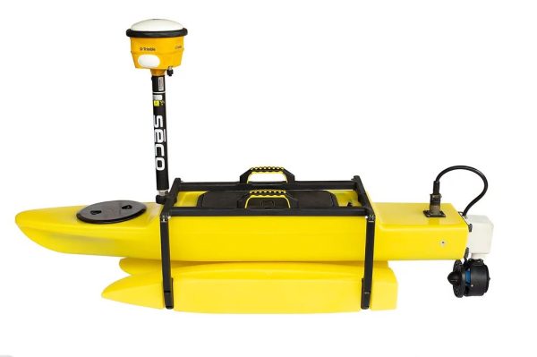 A yellow Seafloor TriDrone™ G2 USV with a radio attached to it.