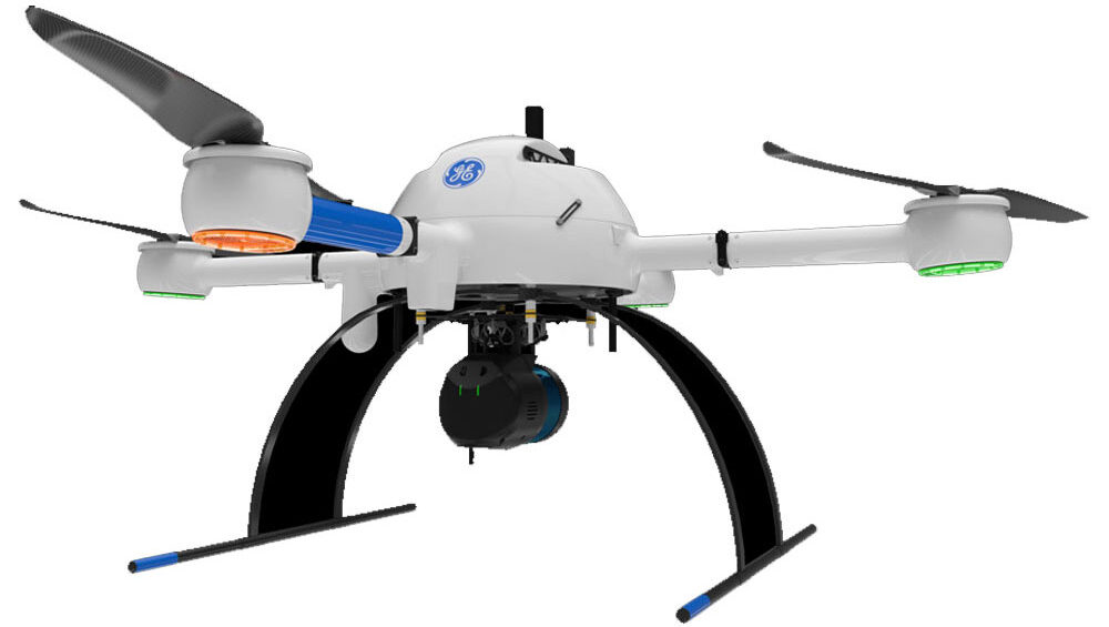 A white and blue Microdrone mdLiDAR1000 UHR is flying in the air.