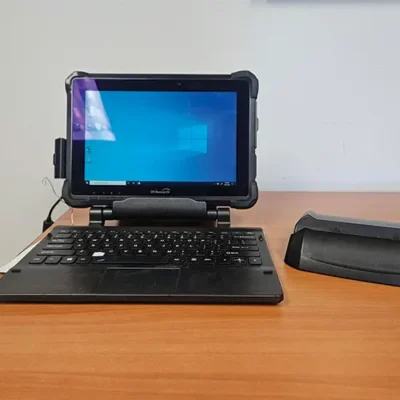 Tablet with keyboard on wooden desk.