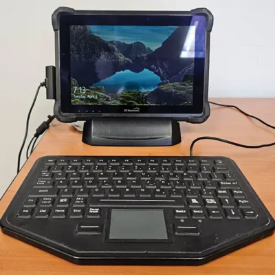 Tablet with keyboard on a wooden desk.
