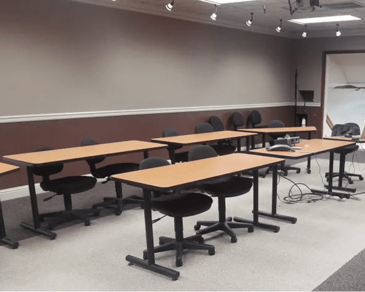 Empty meeting room with tables and chairs.