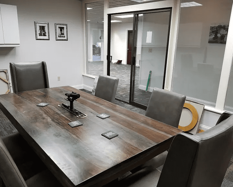 Conference room with a wooden table and chairs.