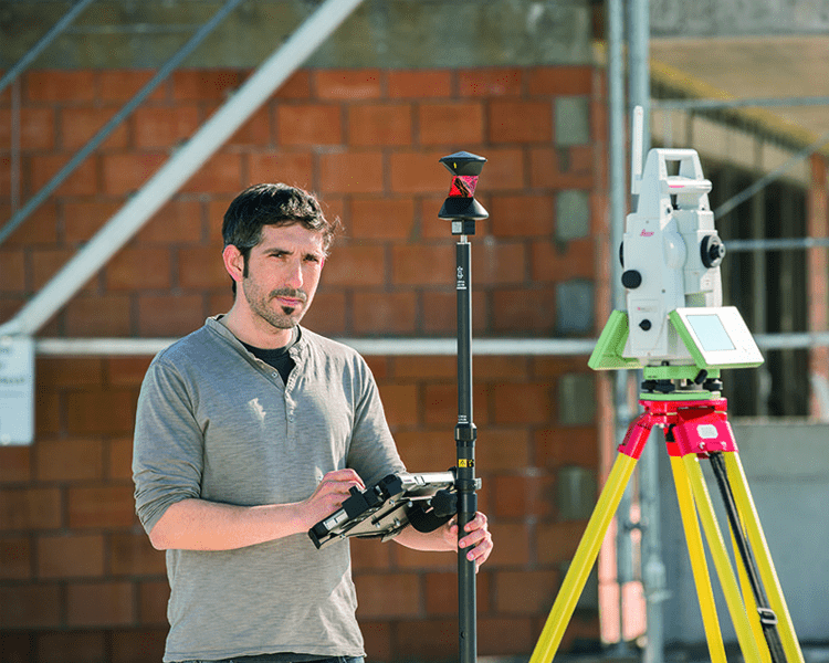 Man using surveying equipment outdoors.