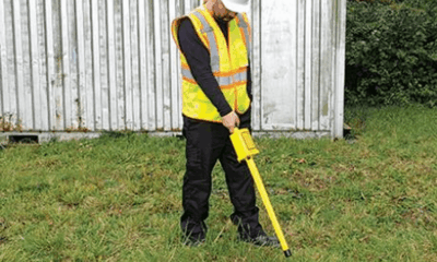 Worker using a yellow ground scanning tool.