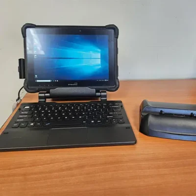 Rugged tablet with keyboard on wooden desk.