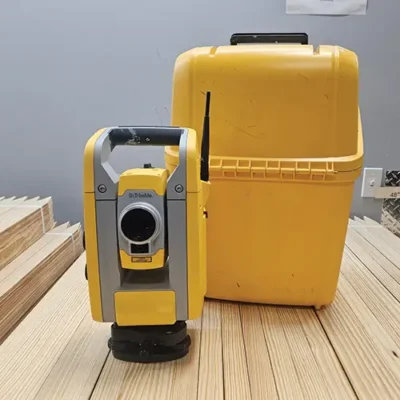 Yellow surveying instrument with matching case.