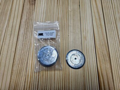 Metal washers on wooden surface, one packaged.