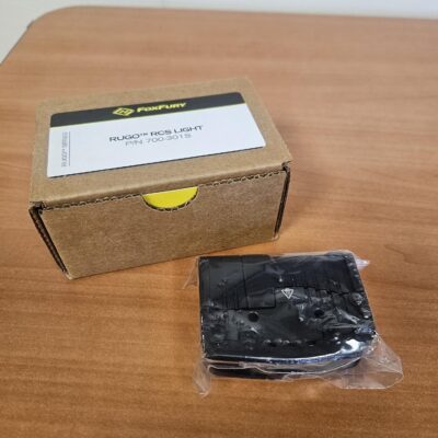 Box and packaged item on table.