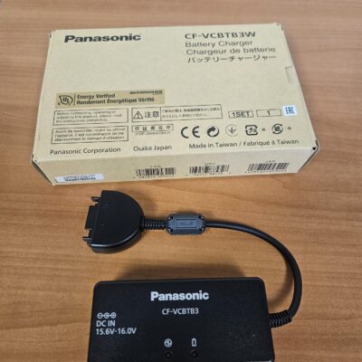 Panasonic battery charger with packaging on table.