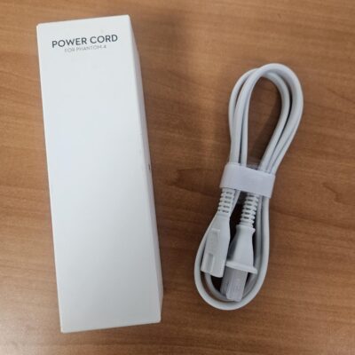 White power cord and box on table.